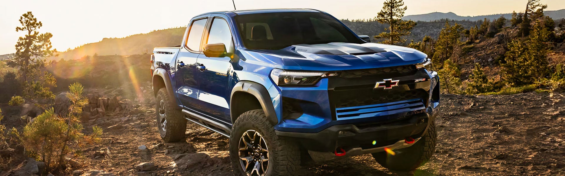 Blue Chevrolet Colorado ZR2 pickup on an off-road trail.