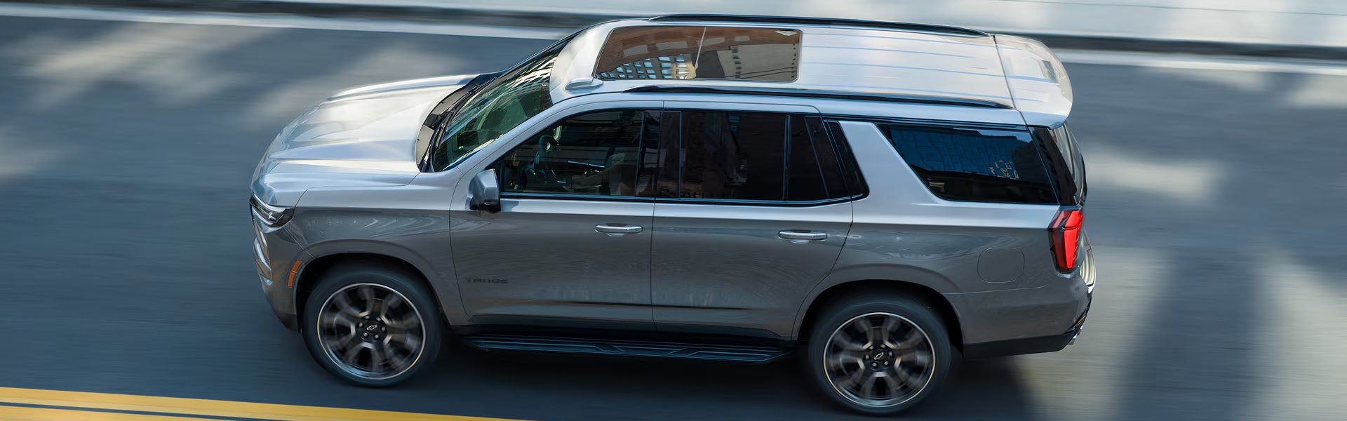 Chevrolet Tahoe driving on a city road.