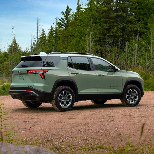 Green Equinox parked on dirt