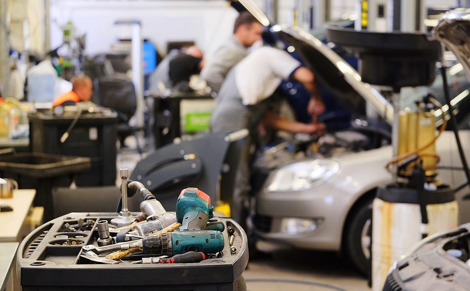 Automotive techs working on vehicles