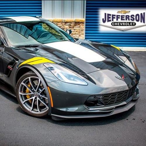 Corvette parked in front of a garage door