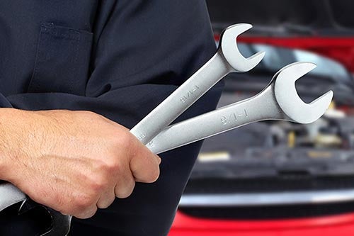A service Specialist holding a wrench